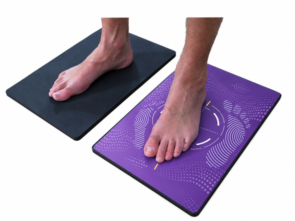 Patient standing on the Qaadir Insight Mini foot scanner